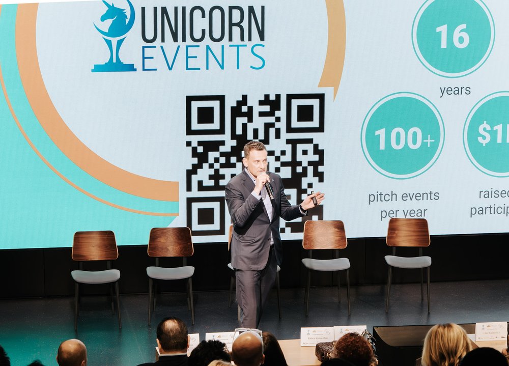 Andrii Moroz presenting Unicorn Events stats on stage